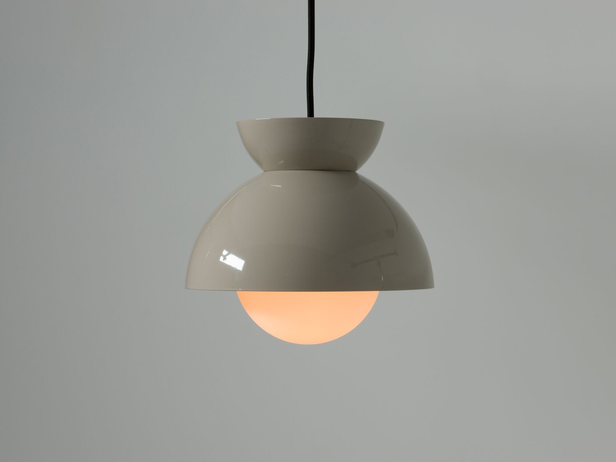 Detail view of modern grey pendant lamp with warm light